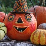 a group of pumpkins with faces painted on them