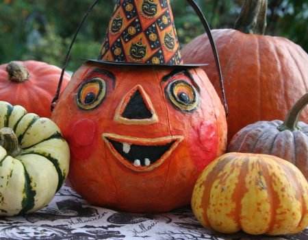 a group of pumpkins with faces painted on them