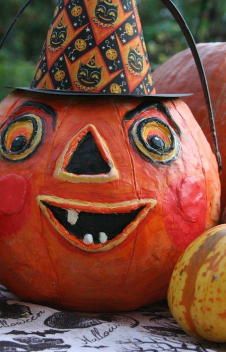 a group of pumpkins with faces painted on them