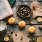 orange fruit beside black round plate on brown wooden table
