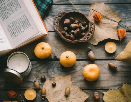 orange fruit beside black round plate on brown wooden table