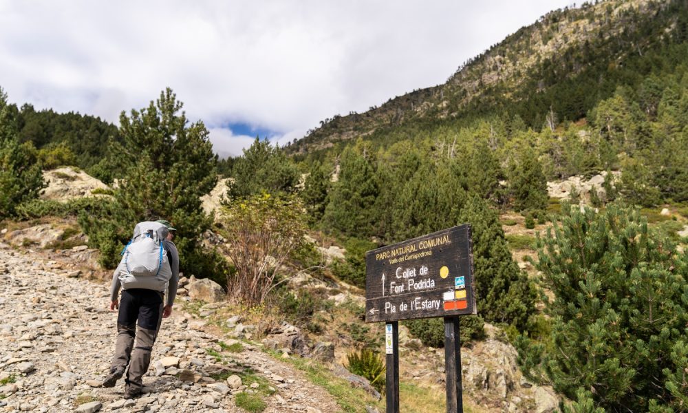 a person with a backpack walking up a hill