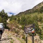 a person with a backpack walking up a hill