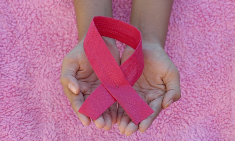 person with pink band on her left hand