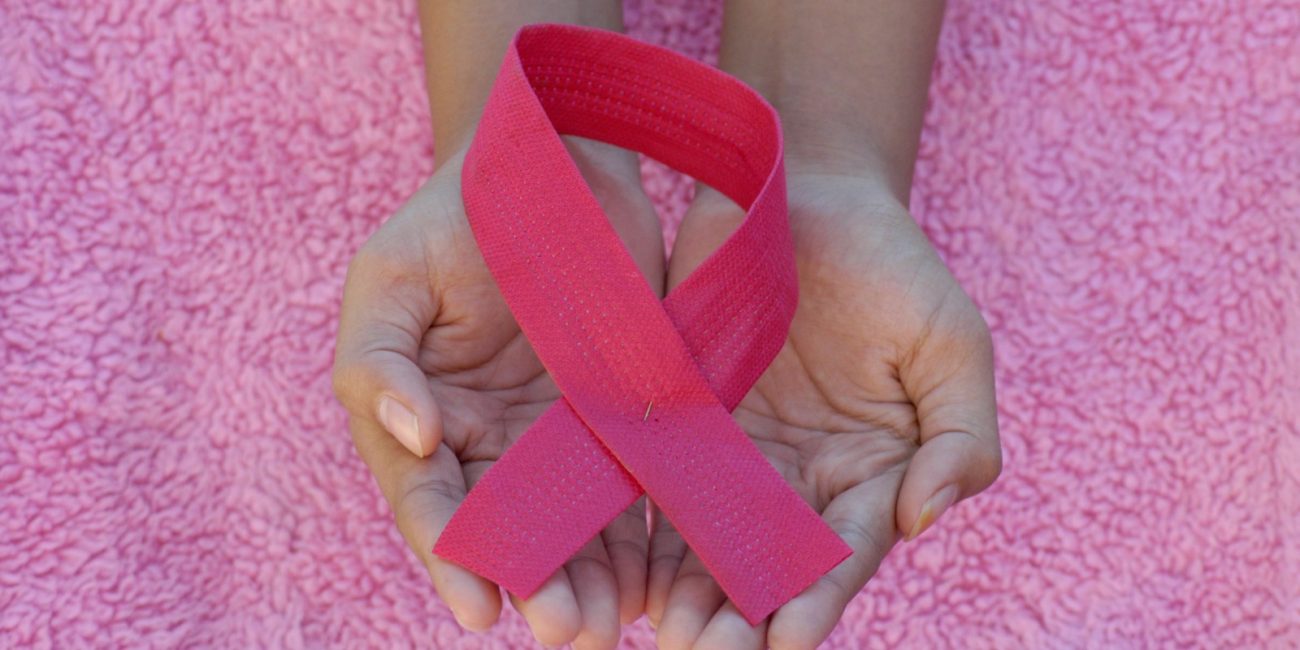 person with pink band on her left hand