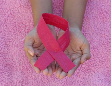 person with pink band on her left hand