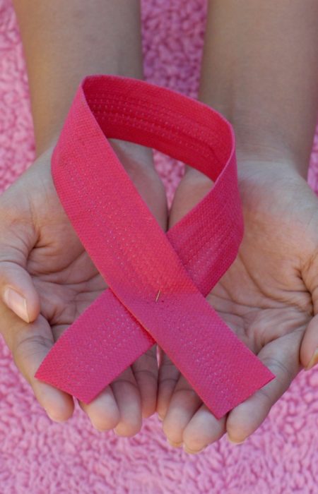person with pink band on her left hand