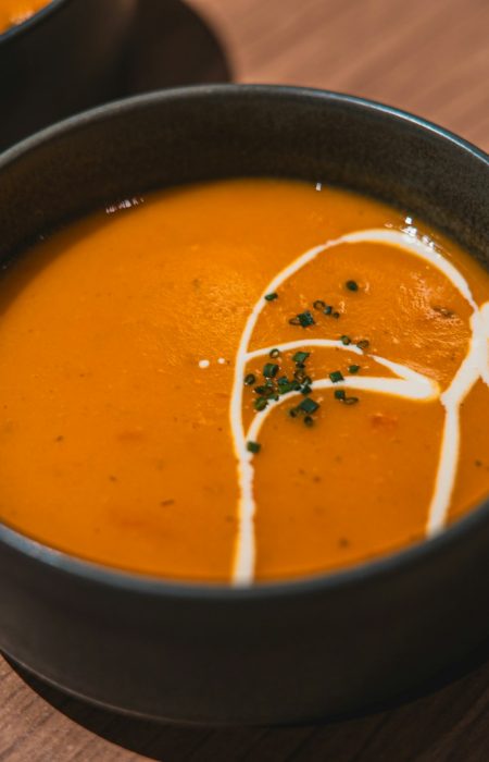 two bowls of soup on a wooden table