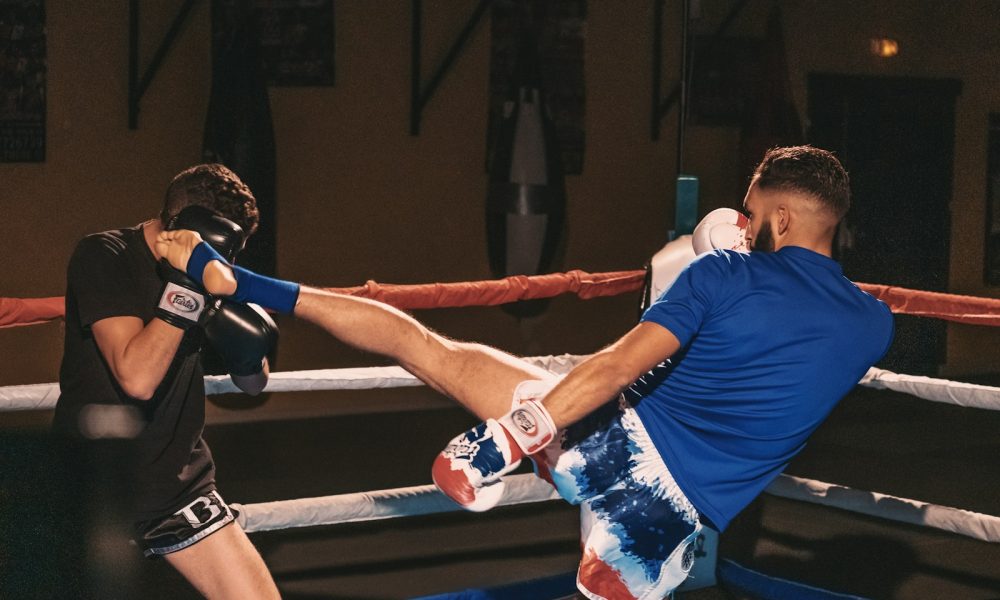 2 men in blue t-shirt and white shorts doing exercise