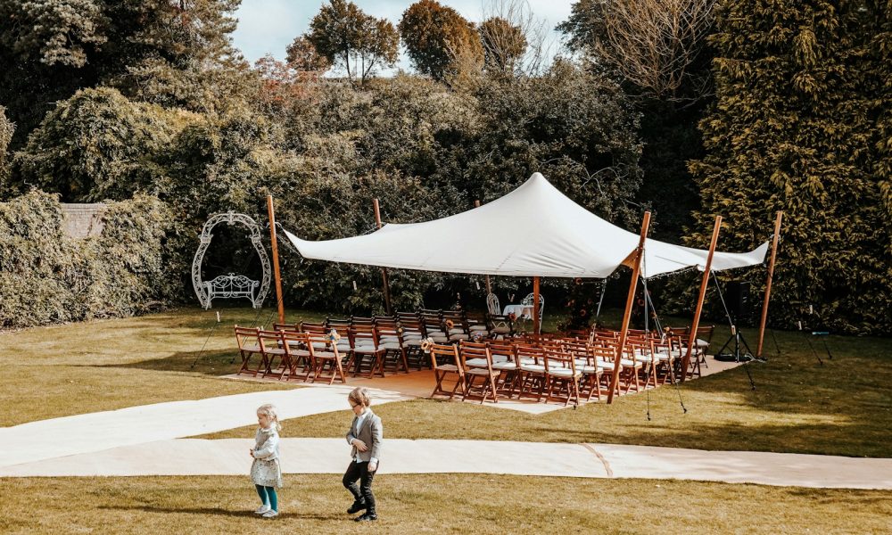 a couple of people that are standing in the grass