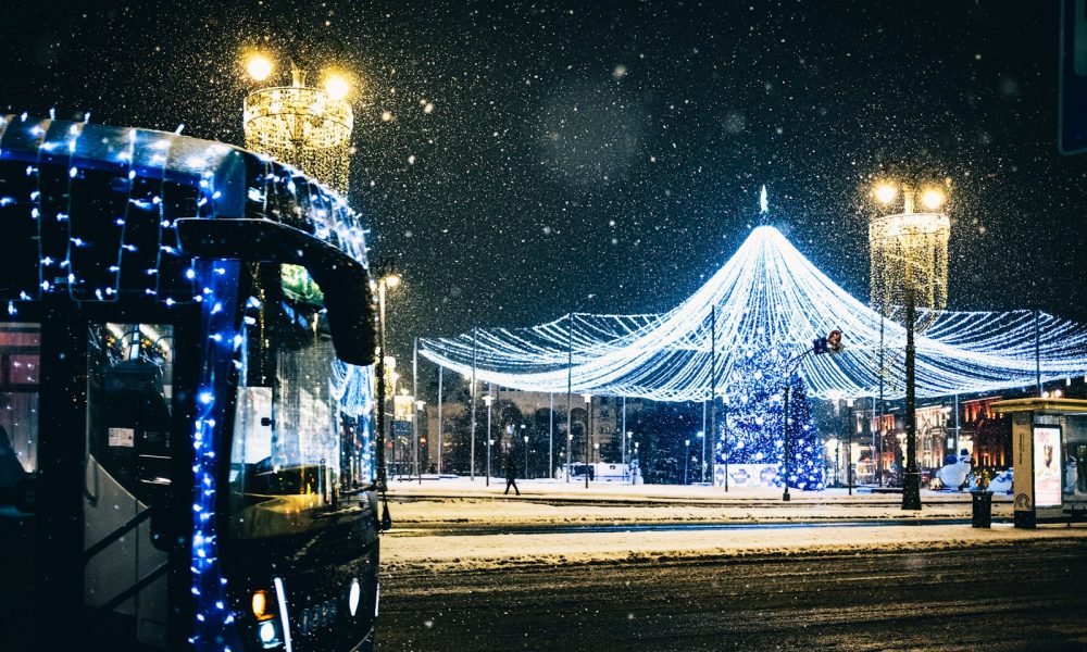 A bus driving down a street covered in snow