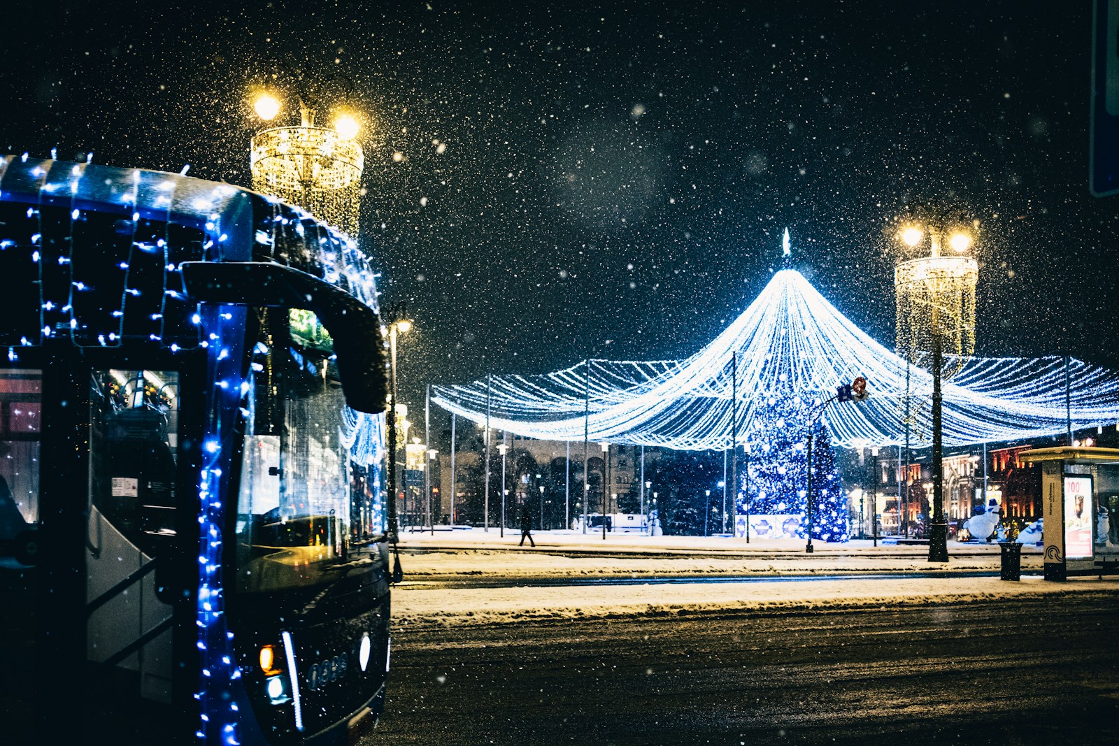 A bus driving down a street covered in snow