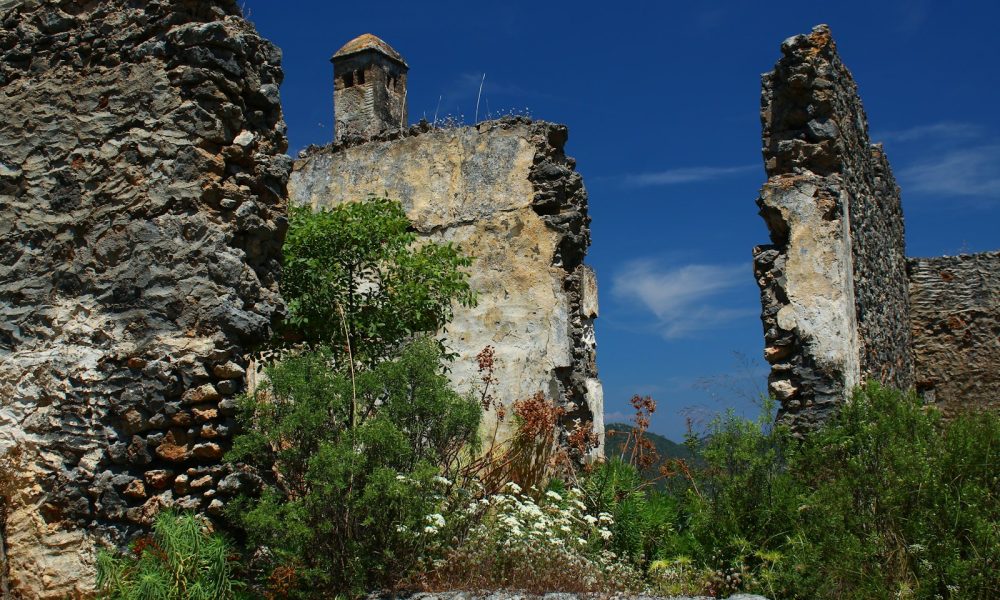 a stone wall with a clock tower on top of it