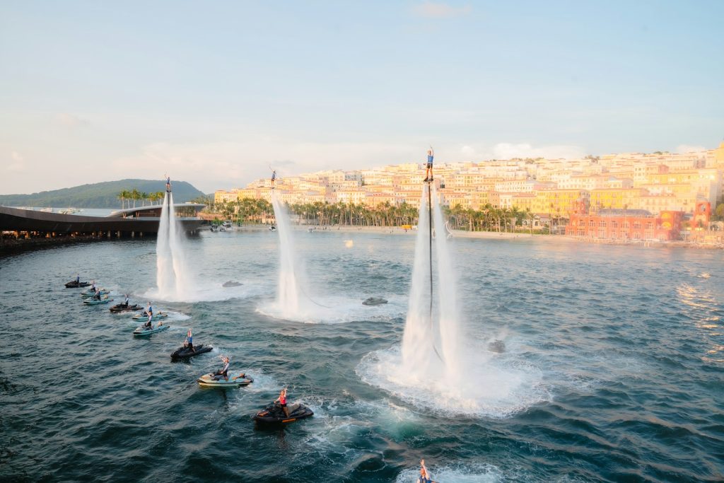 A group of people riding jet skis on top of a lake