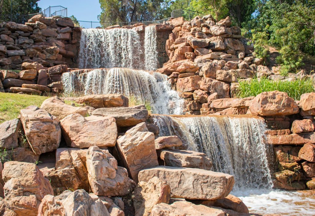 brown rock formation near waterfalls during daytime