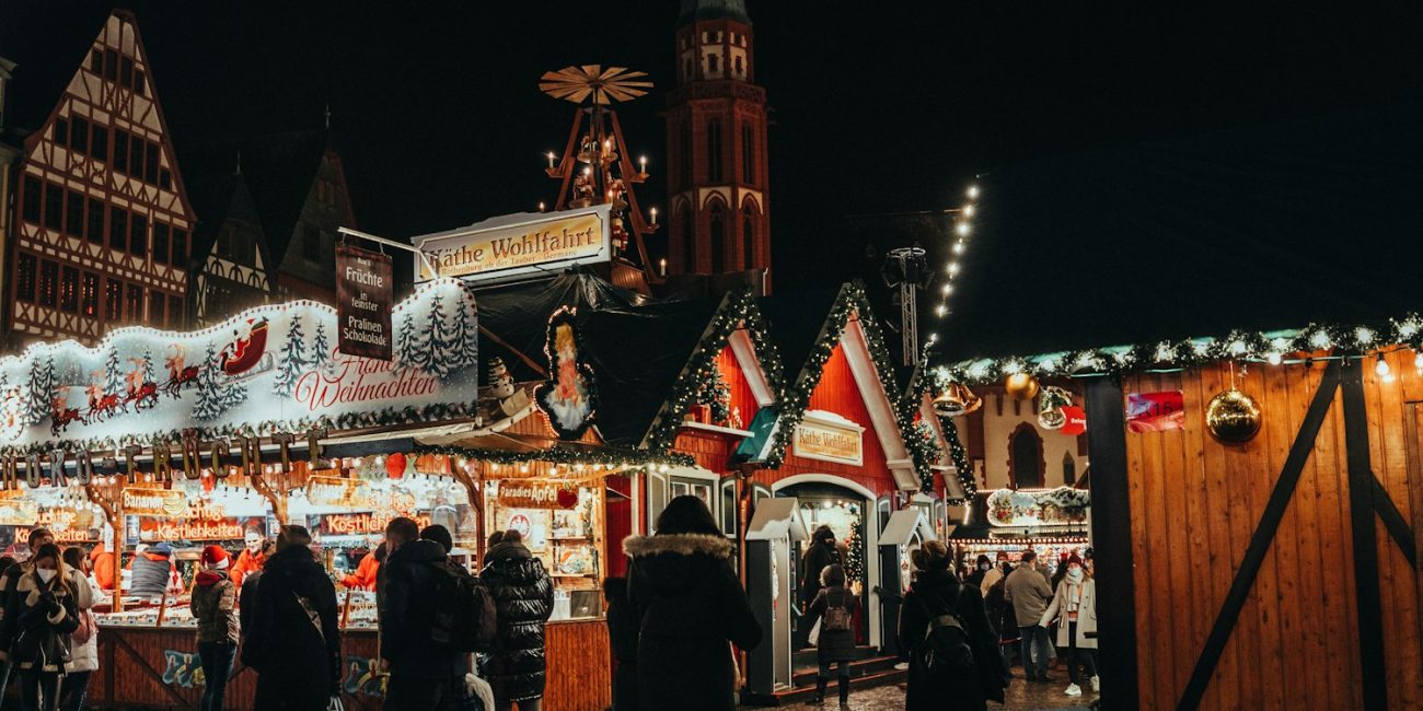 a group of people walking around a christmas market