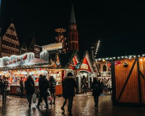a group of people walking around a christmas market