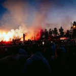 A large crowd of people watching a concert