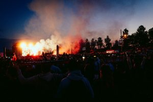 A large crowd of people watching a concert