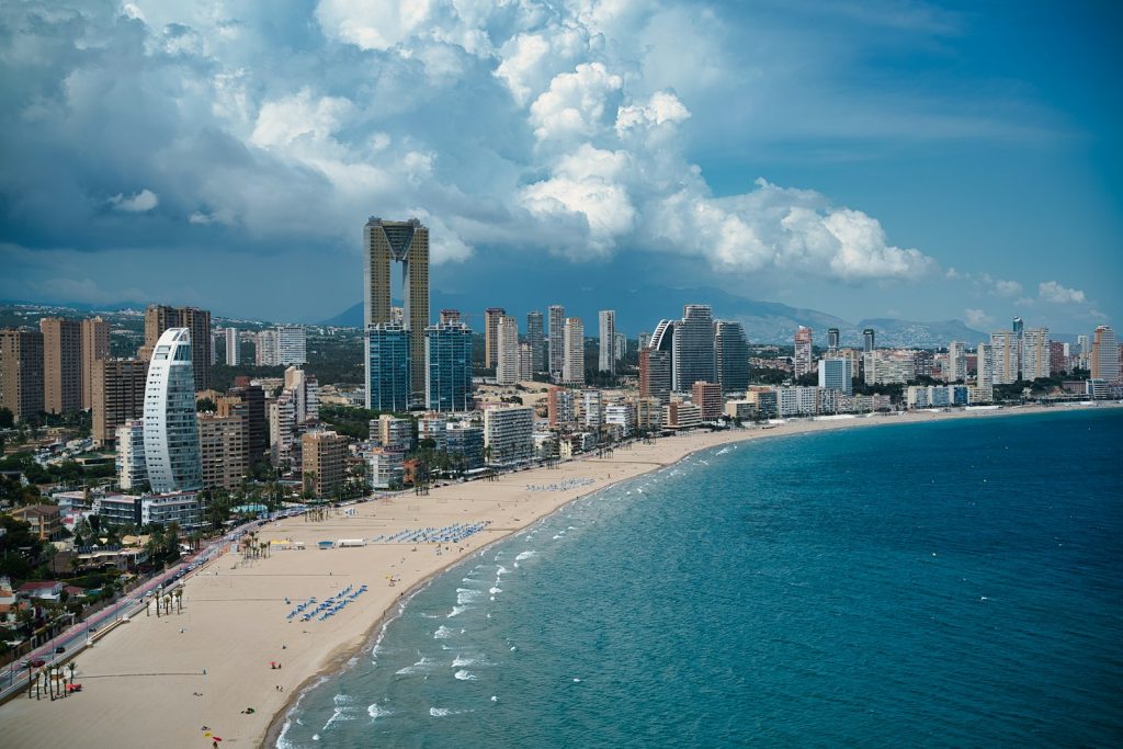 A view of a beach with a city in the background