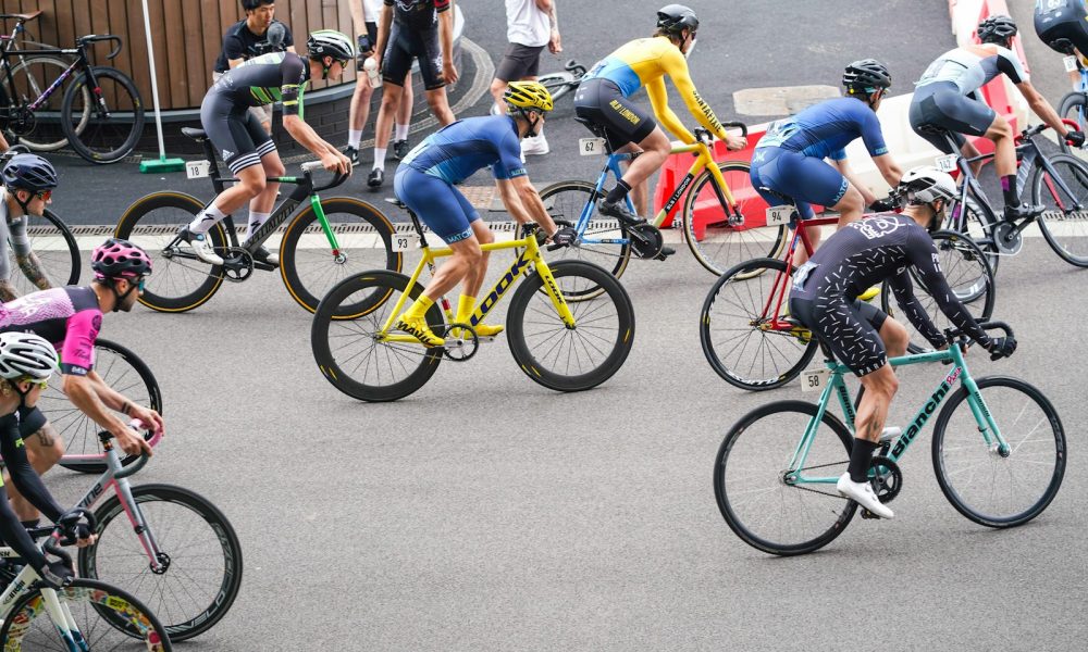 people riding on bicycle cycling at daytime