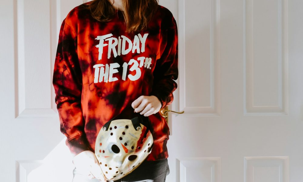 a woman in a tie dye shirt holding a dice bag