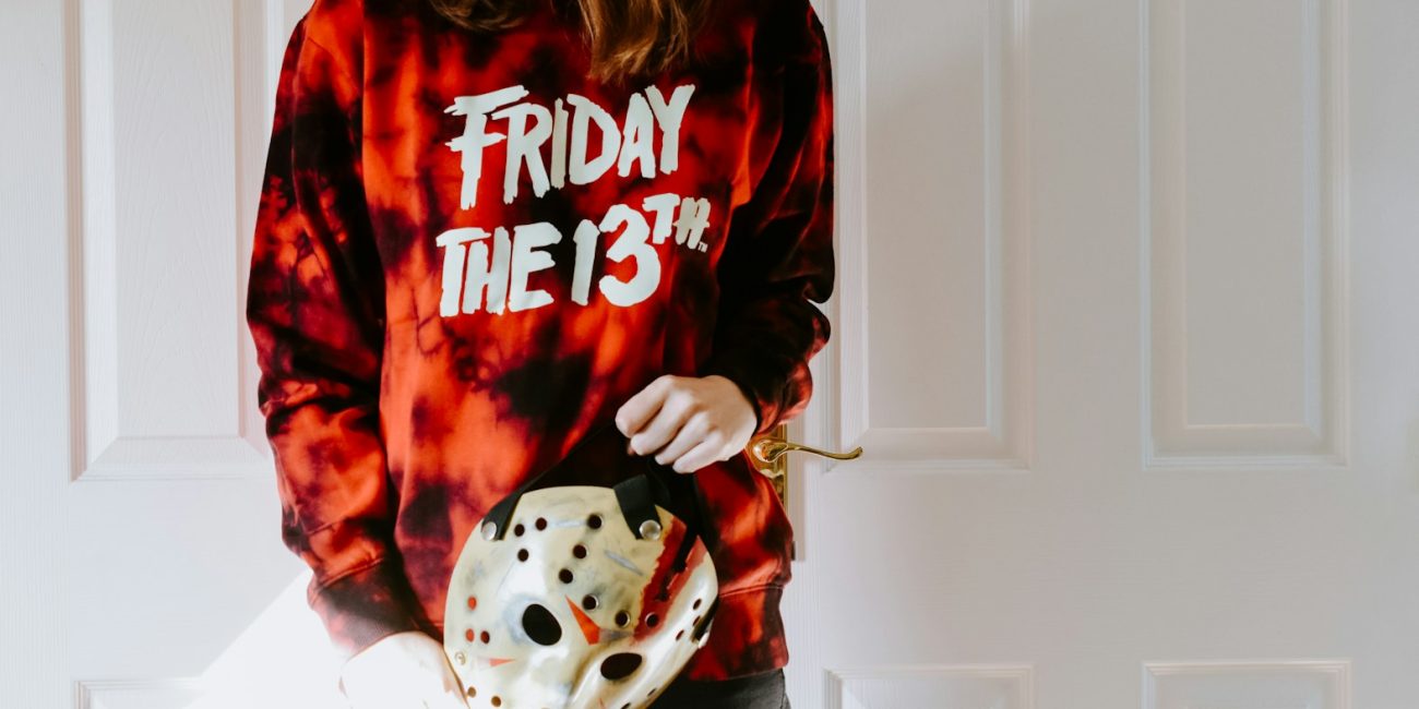 a woman in a tie dye shirt holding a dice bag